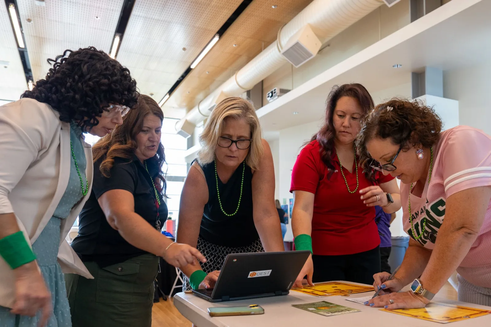 District leaders working through a problem together around a laptop